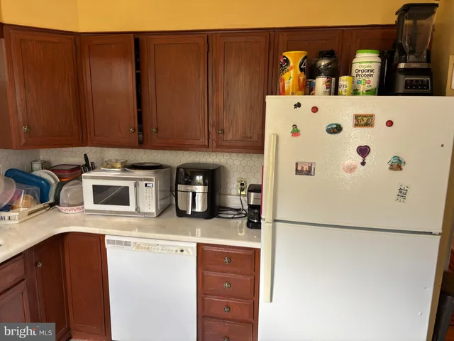 a kitchen with refrigerator and cabinets