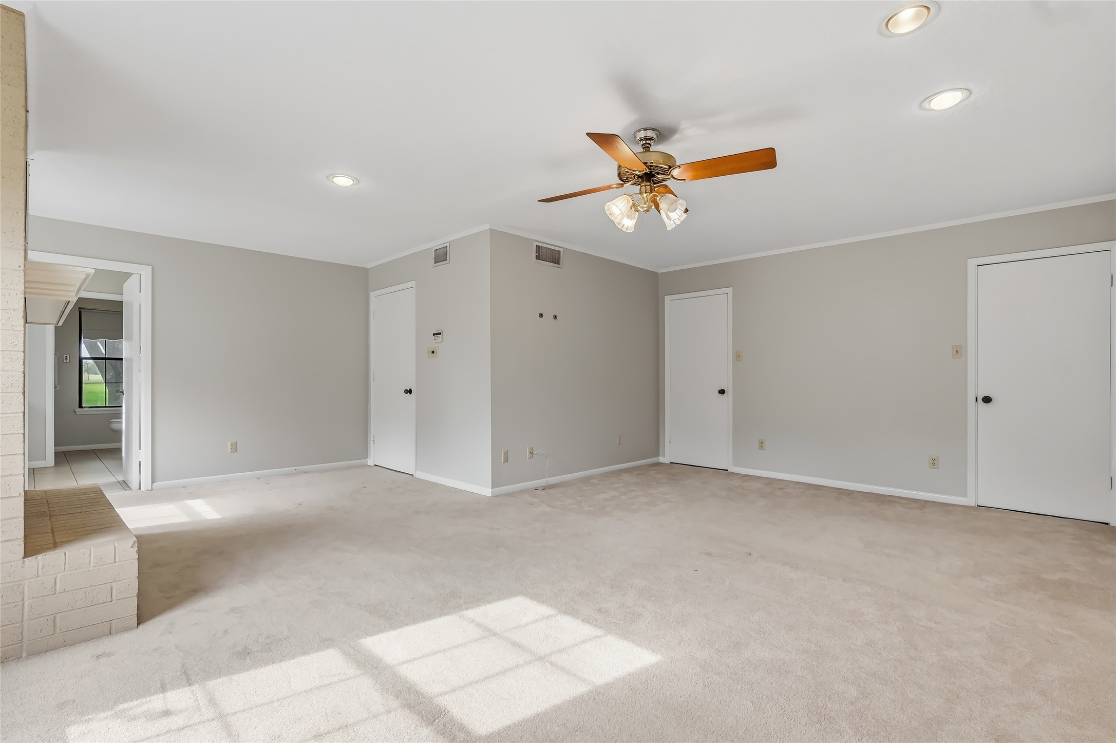 807 Standley Road Madisonville, TX 77864 - Photo 30 of 35 an empty room with chandelier fan and windows
