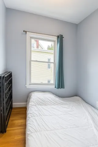 a bedroom with a bed and a window