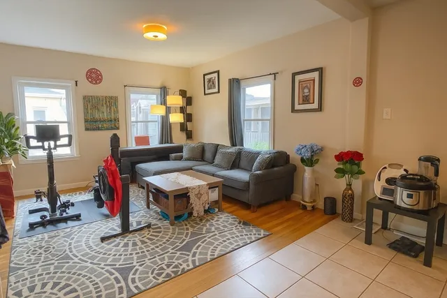 a living room with furniture chess table and a window