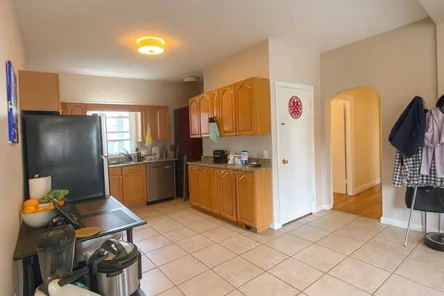 a kitchen with stainless steel appliances granite countertop a refrigerator and a stove top oven