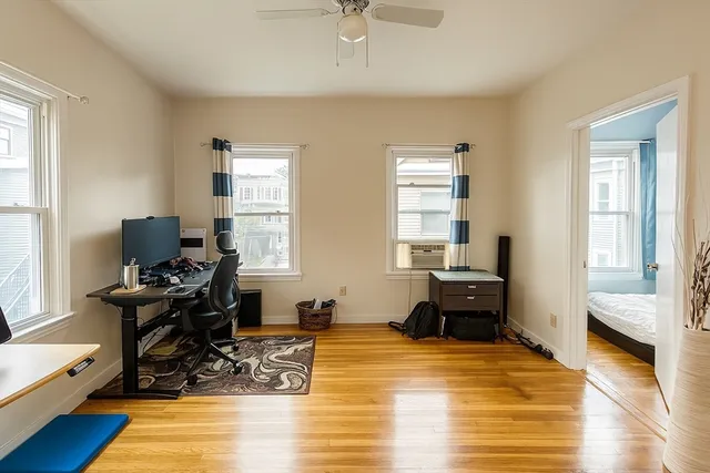 a bedroom with a bed and wooden floor