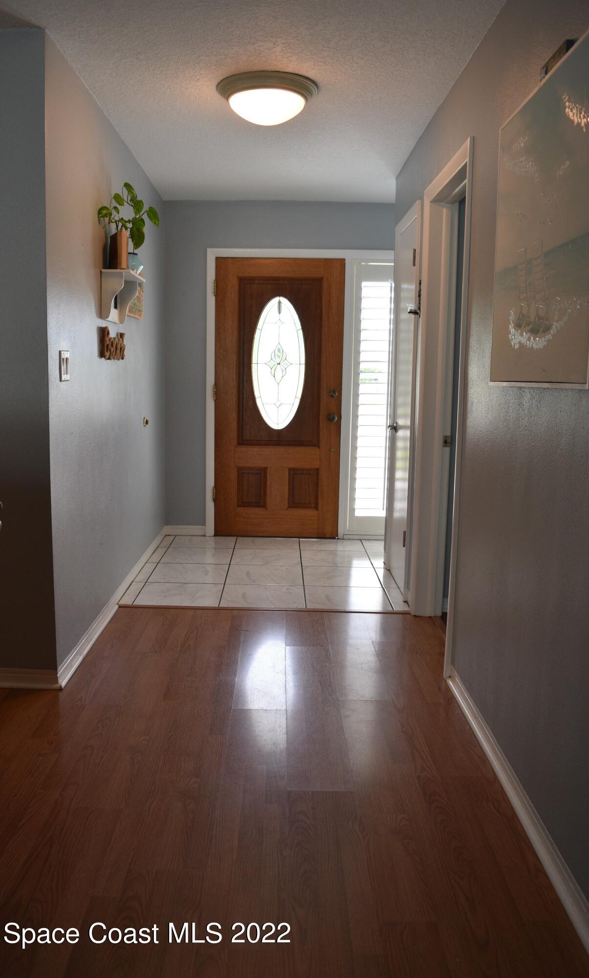 511 South Sonora Circle Indialantic, FL 32903 - Photo 2 of 10 an empty room with windows and entrance