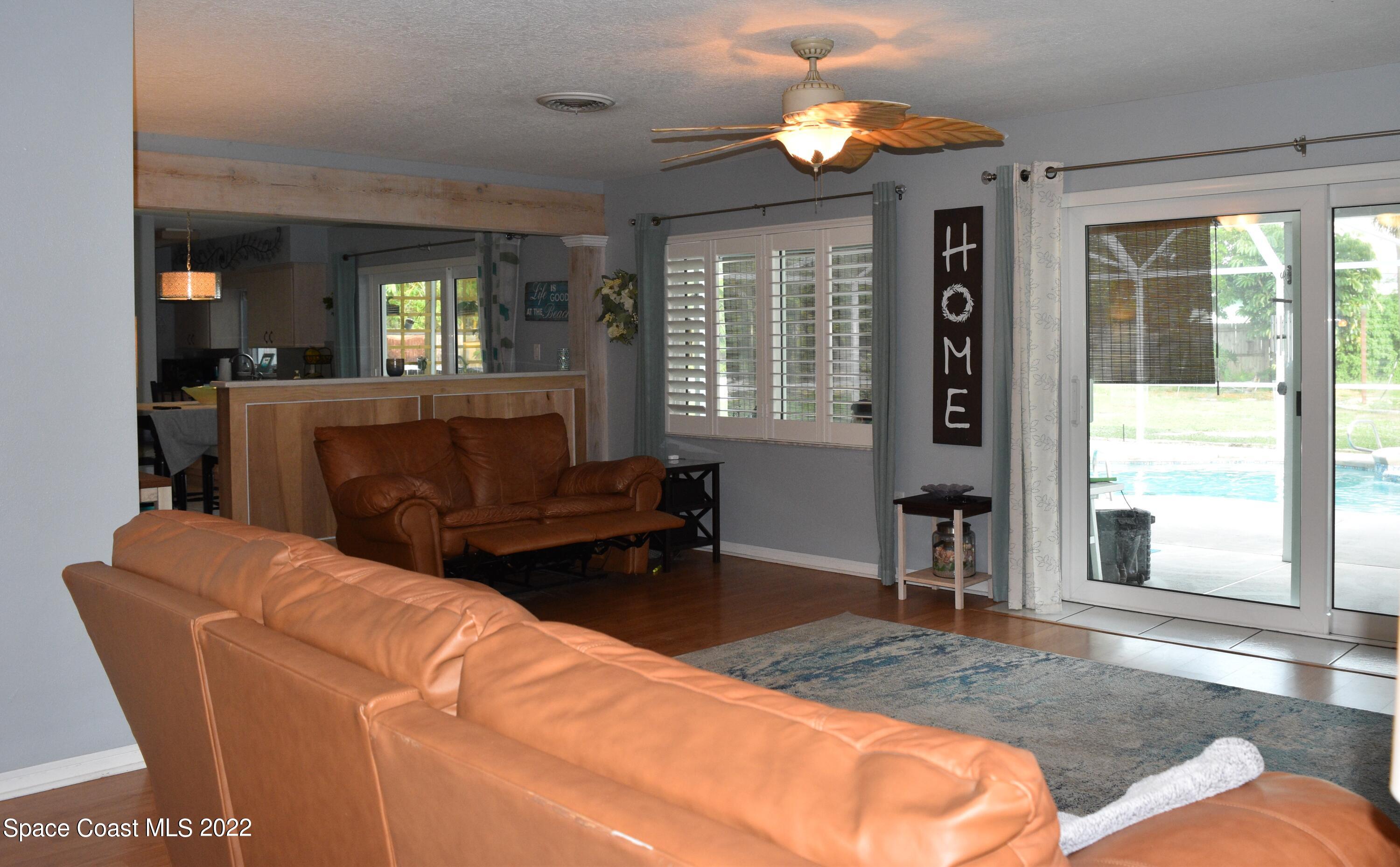 511 South Sonora Circle Indialantic, FL 32903 - Photo 4 of 10 a living room with furniture a window and a chandelier