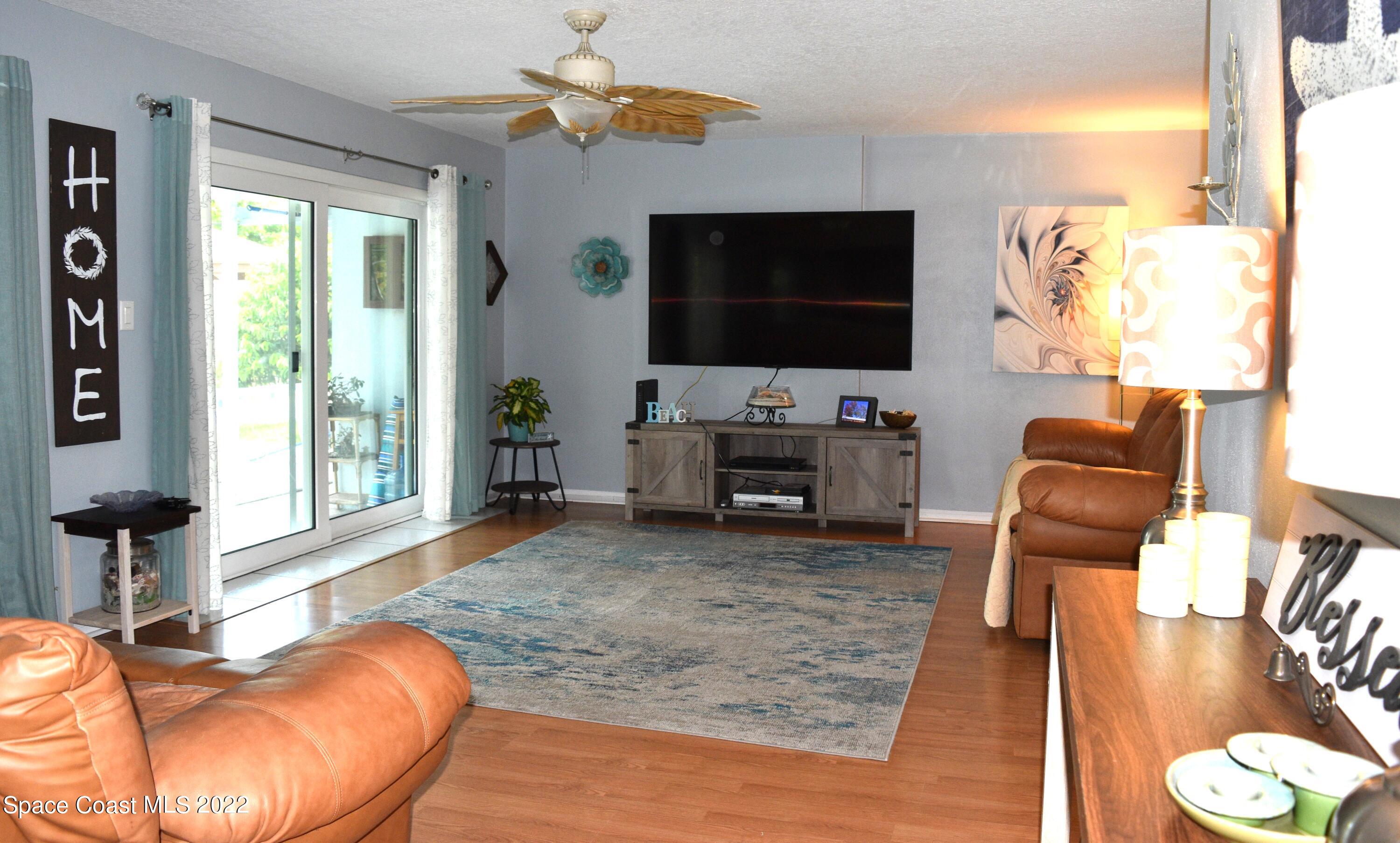 511 South Sonora Circle Indialantic, FL 32903 - Photo 5 of 10 a living room with furniture and a flat screen tv