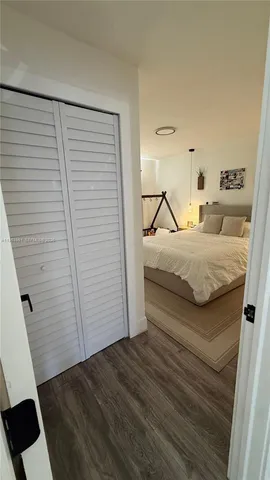 a bedroom with a bed and cabinets
