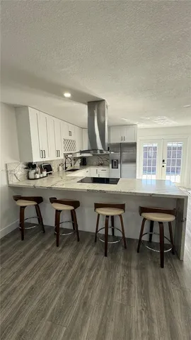a dining room with wooden floor a table and chairs