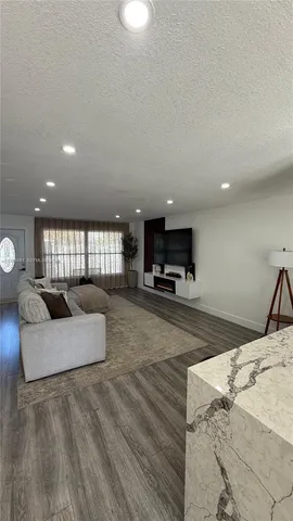 a living room with furniture a couch and potted plant