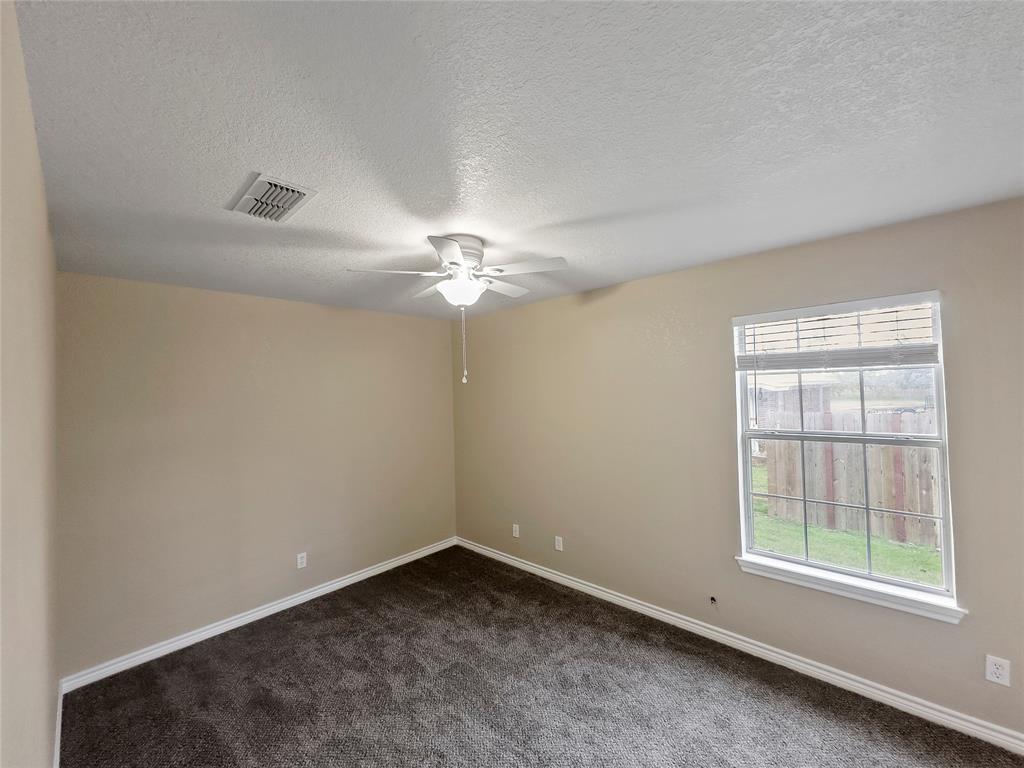 225 Oak Court, Unit 225 Rhome, TX 76078 - Photo 13 of 30 an empty room with a window