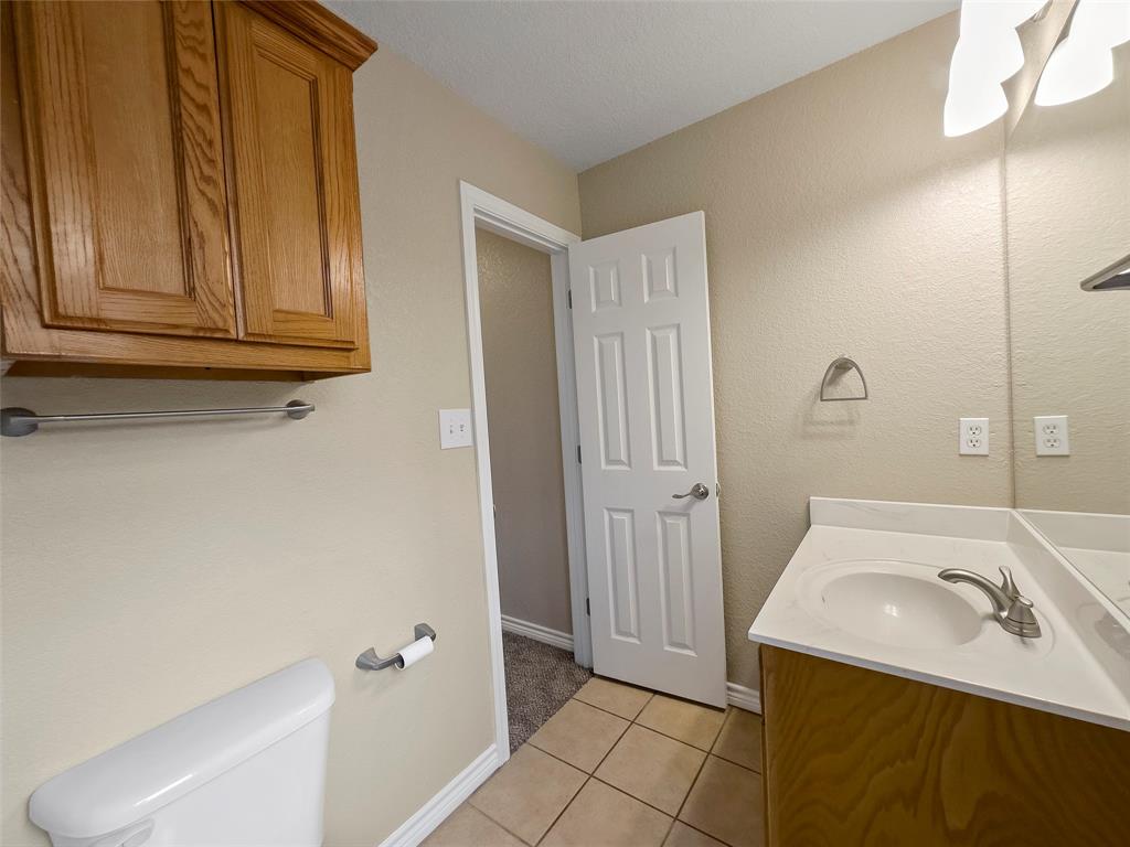 225 Oak Court, Unit 225 Rhome, TX 76078 - Photo 15 of 30 a bathroom with a sink and a mirror
