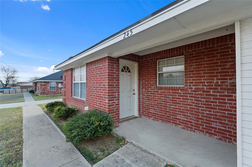 225 Oak Court, Unit 225 Rhome, TX 76078 - Photo 2 of 30 a front view of a house with garden