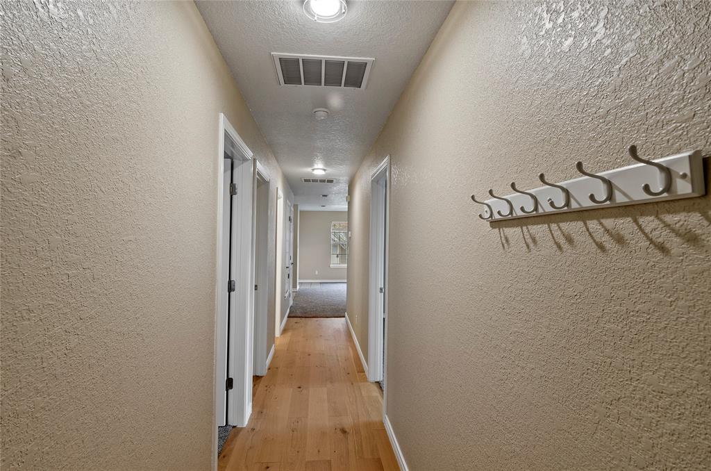 225 Oak Court, Unit 225 Rhome, TX 76078 - Photo 21 of 30 a view of a hallway with wooden floor