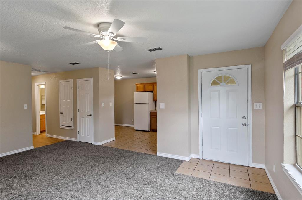 225 Oak Court, Unit 225 Rhome, TX 76078 - Photo 6 of 30 a view of a livingroom with a chandelier fan and windows