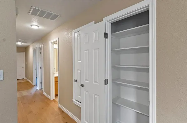 a view of a hallway with walk in closet