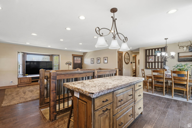 781 West 3000 South Heber City, UT 84032 - Photo 9 of 30 Kitchen featuring a kitchen island, dark wood-style floors, a kitchen bar, and wood finish cabinetry