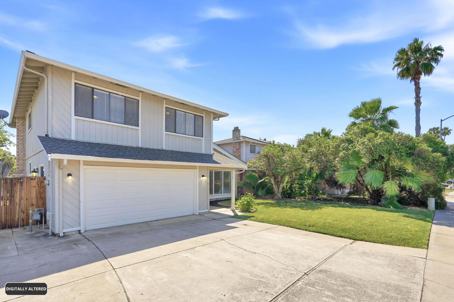 5501 Riverlake Road Discovery Bay, CA 94505 - Photo 5 of 60 a front view of a house with a yard and garage