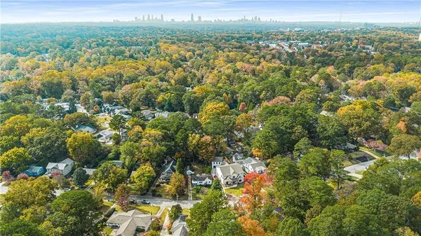an aerial view of residential houses with outdoor space and trees