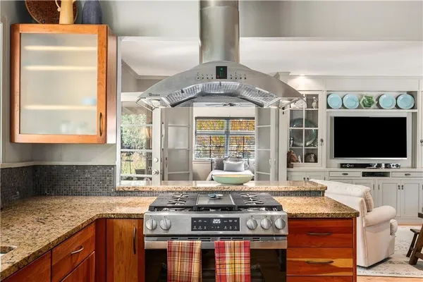 a kitchen with granite countertop a stove and a sink
