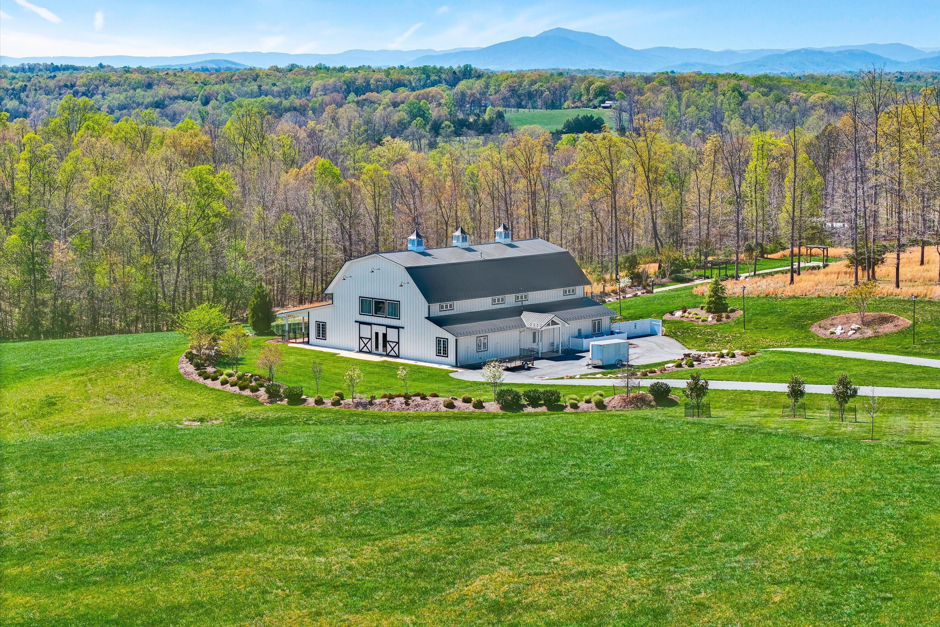 9945 Brooks Mill Road Wirtz, VA 24184 - Photo 2 of 69 a view of a house with a big yard and large trees