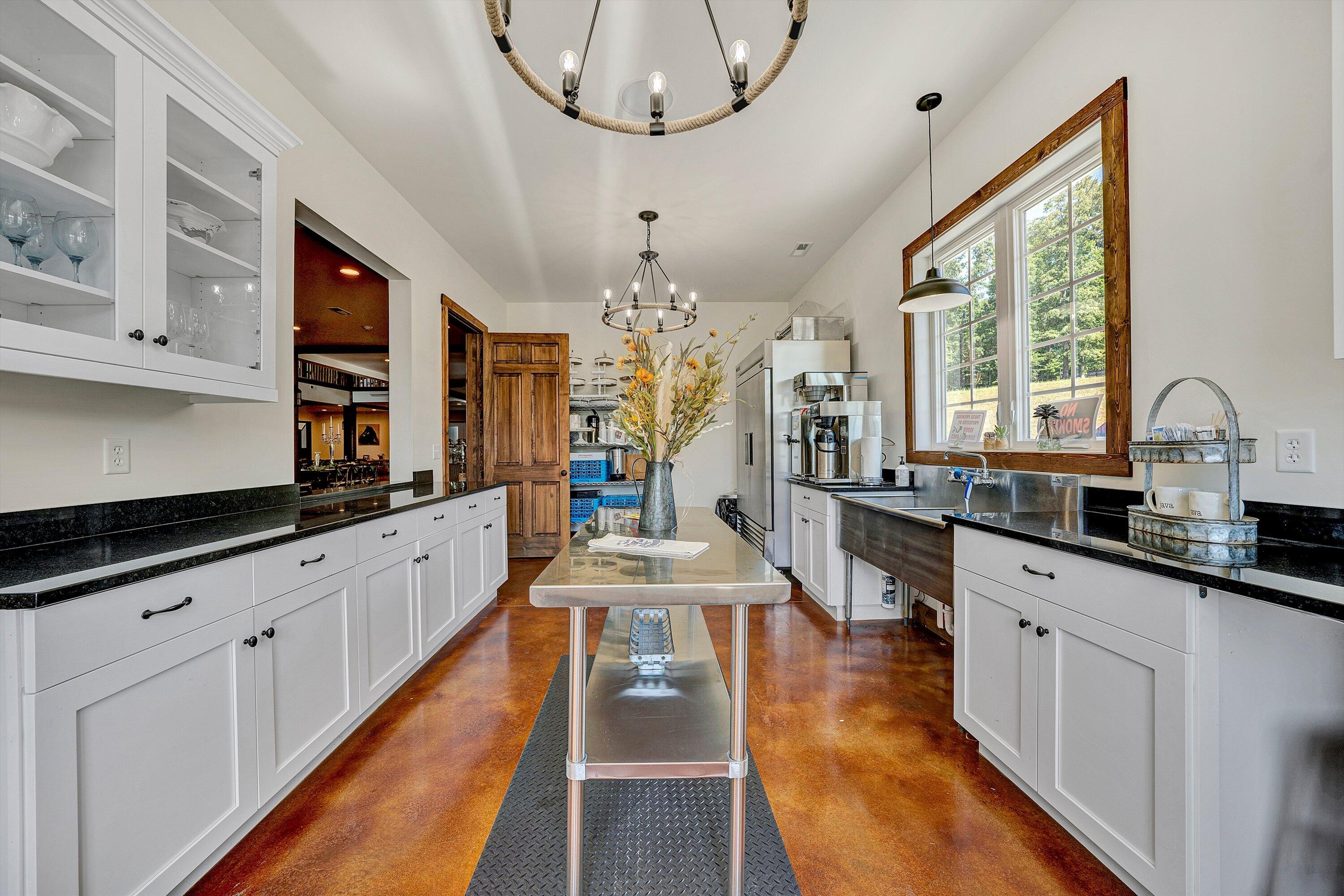 9945 Brooks Mill Road Wirtz, VA 24184 - Photo 25 of 69 a large kitchen with kitchen island lots of counter space wooden floor and stainless steel appliances