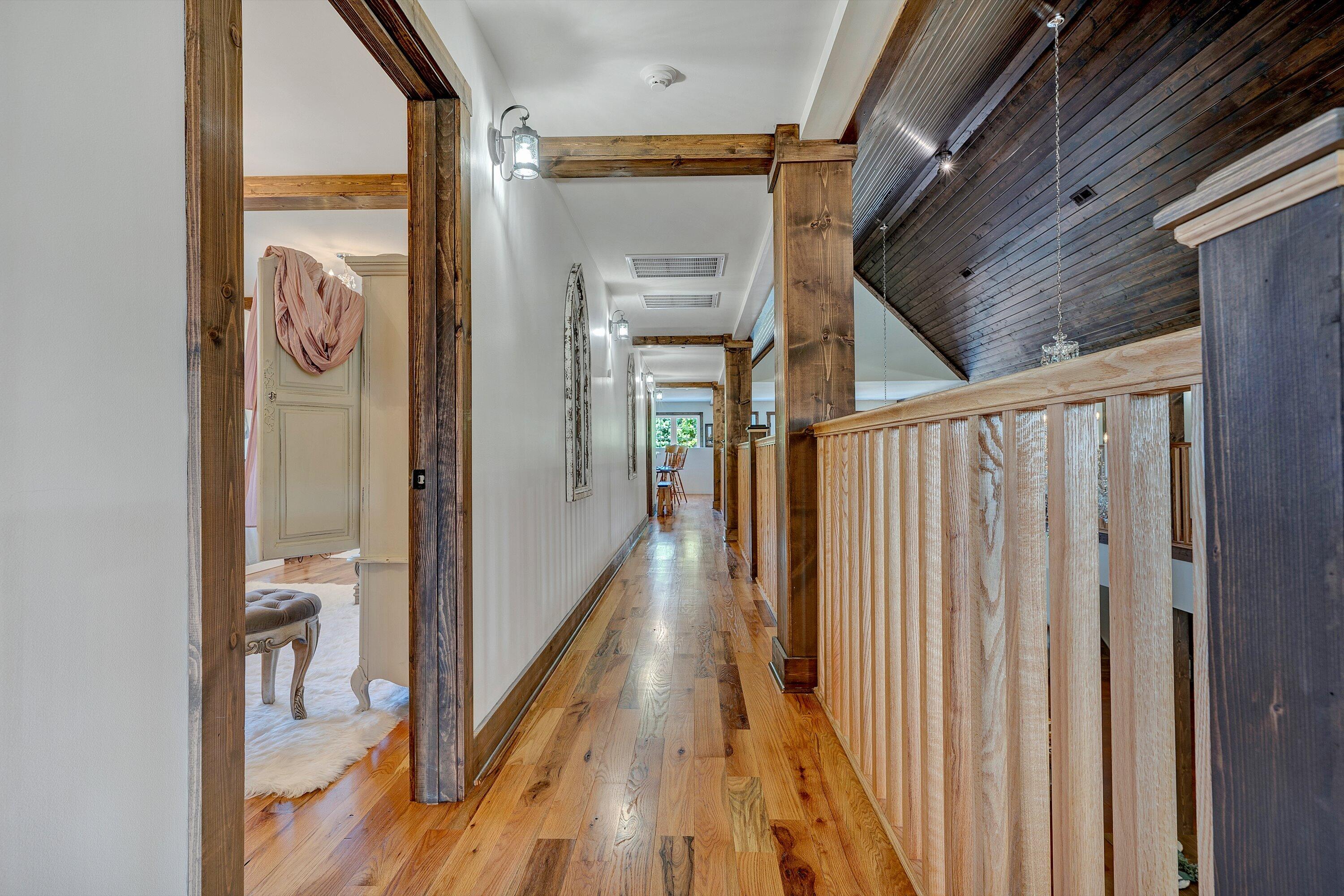 9945 Brooks Mill Road Wirtz, VA 24184 - Photo 52 of 69 a view of a hallway with wooden floor and staircase