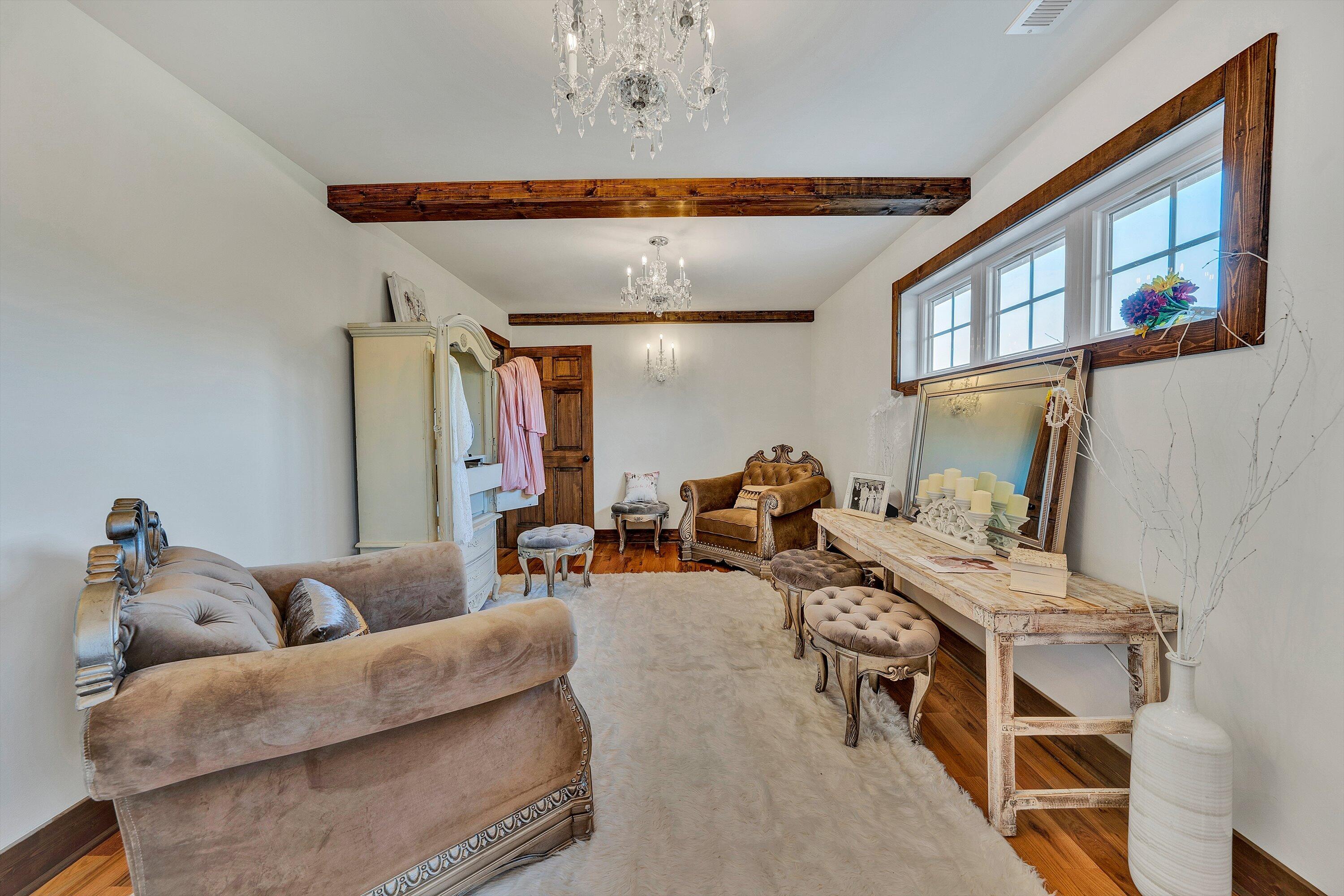 9945 Brooks Mill Road Wirtz, VA 24184 - Photo 55 of 69 a living room with furniture and a chandelier