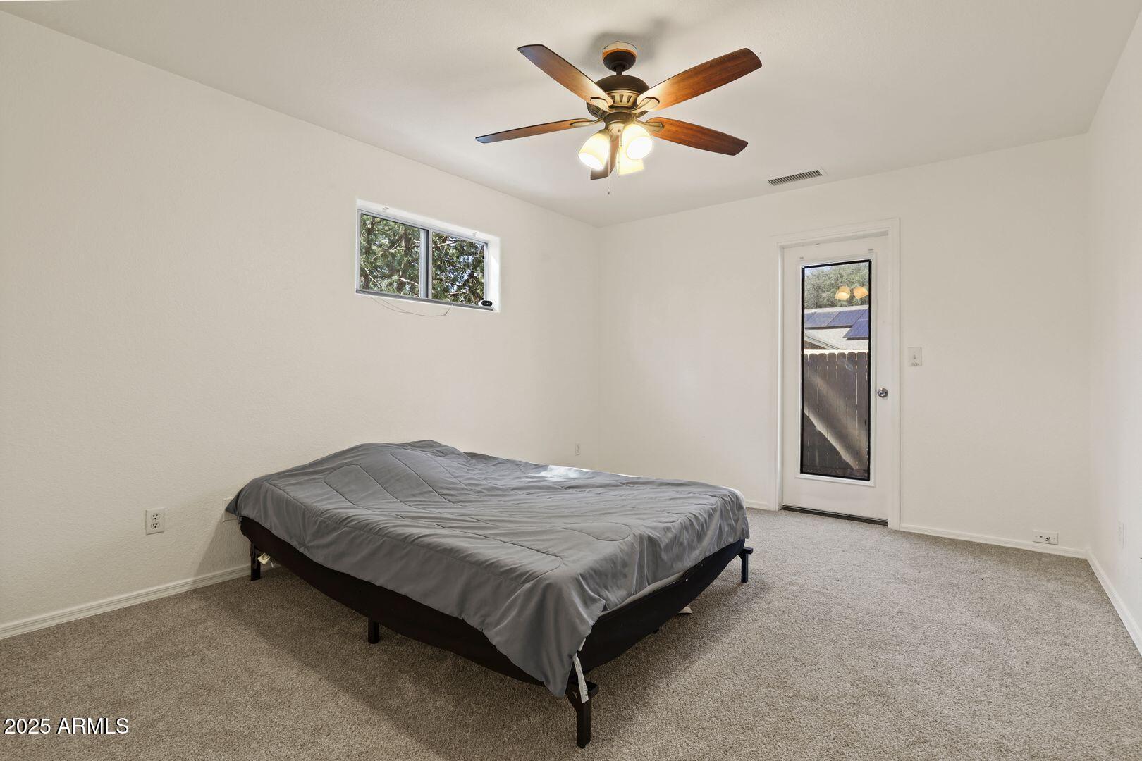 510 North Oak Ridge Road Payson, AZ 85541 - Photo 17 of 36 a bed sitting in a bedroom next to a window
