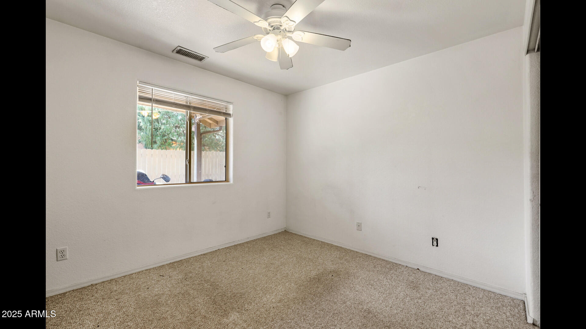 510 North Oak Ridge Road Payson, AZ 85541 - Photo 20 of 36 an empty room with a window and a fan