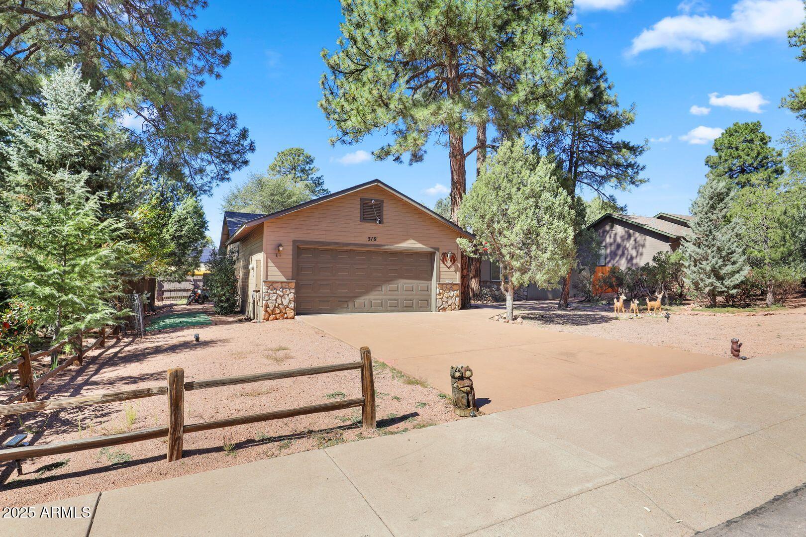 510 North Oak Ridge Road Payson, AZ 85541 - Photo 2 of 36 a white house that has a tree in front of it