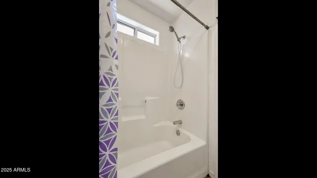 a bathroom with a bathtub and shower