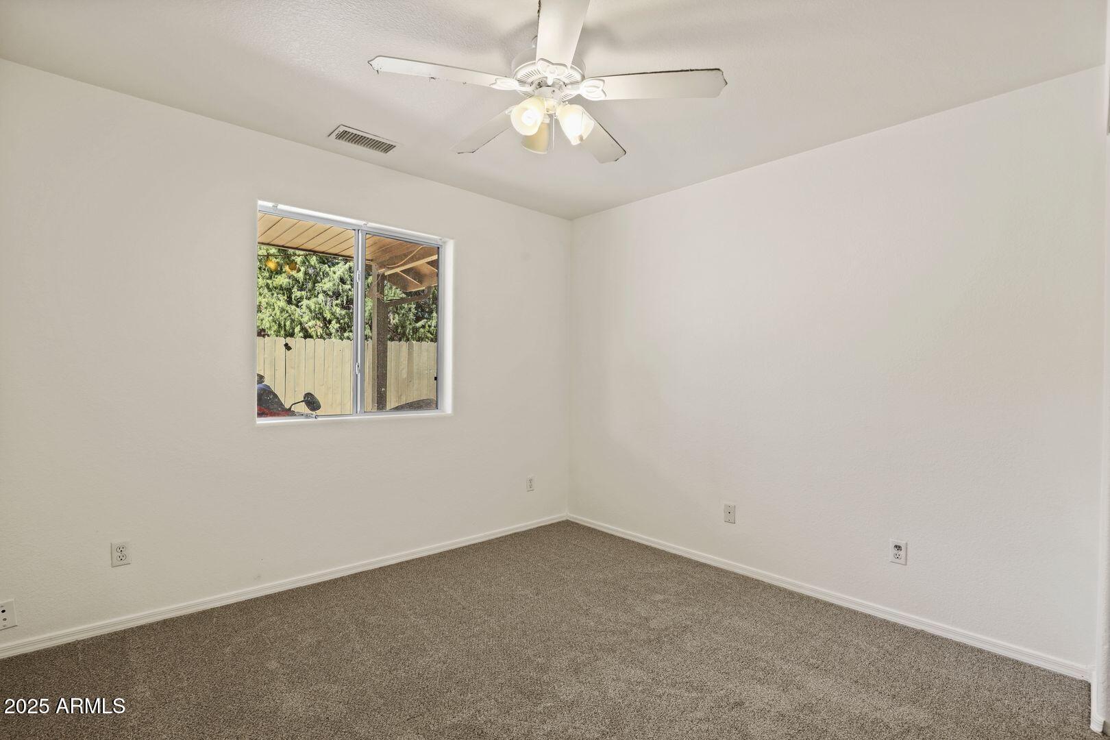510 North Oak Ridge Road Payson, AZ 85541 - Photo 32 of 36 an empty room with a window and a fan