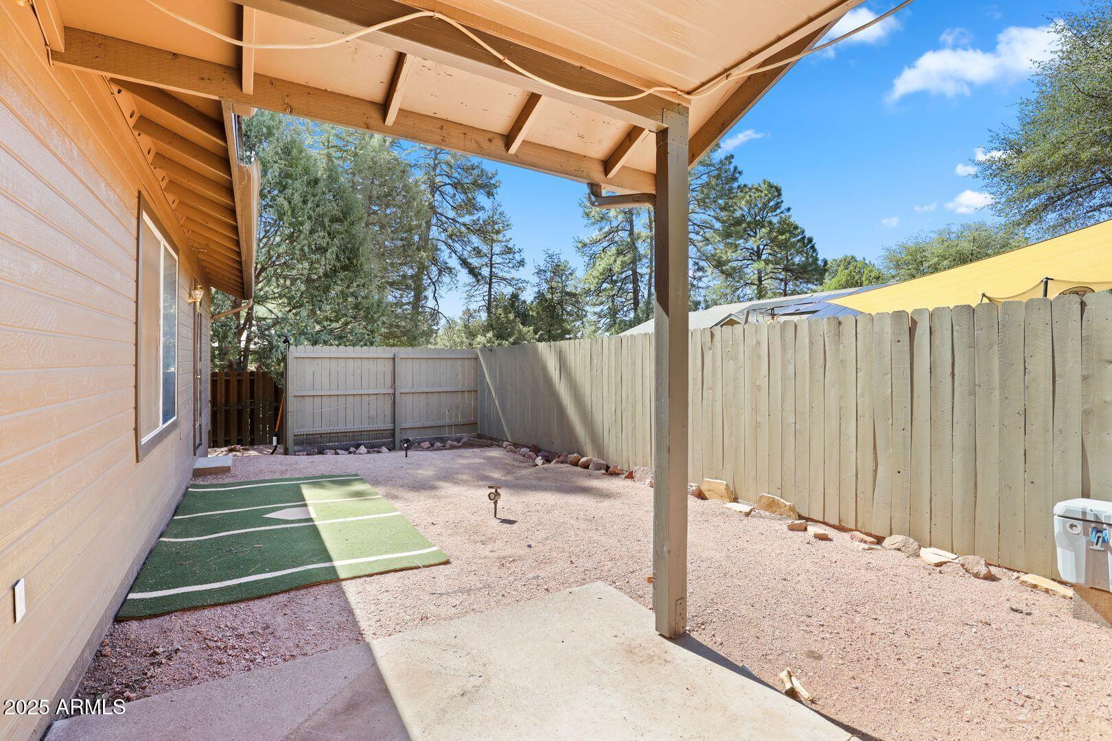 510 North Oak Ridge Road Payson, AZ 85541 - Photo 36 of 36 a view of a backyard with wooden fence and large trees