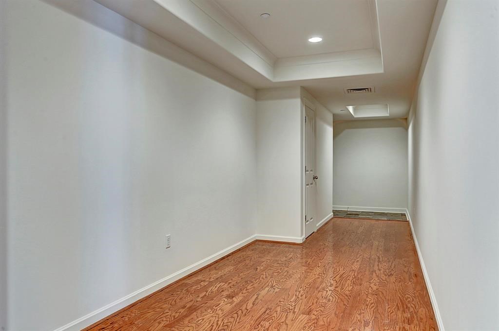 914 Main Street, Unit 1806 Houston, TX 77002 - Photo 3 of 21 a view of hallway with wooden floor