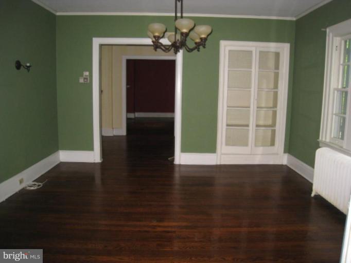 5305 Falls Rd Terrace Baltimore, MD 21210 - Photo 2 of 20 a view of a livingroom with wooden floor and a kitchen