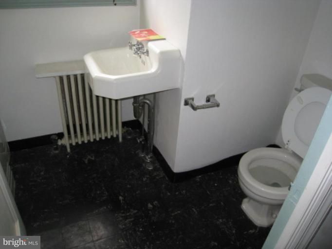 5305 Falls Rd Terrace Baltimore, MD 21210 - Photo 11 of 20 a bathroom with a sink toilet and a mirror