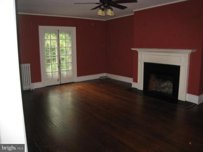 5305 Falls Rd Terrace Baltimore, MD 21210 - Photo 3 of 20 a view of a livingroom with furniture a fireplace and wooden floor