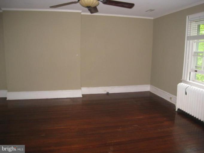 5305 Falls Rd Terrace Baltimore, MD 21210 - Photo 6 of 20 a view of a room with wooden floor and a window