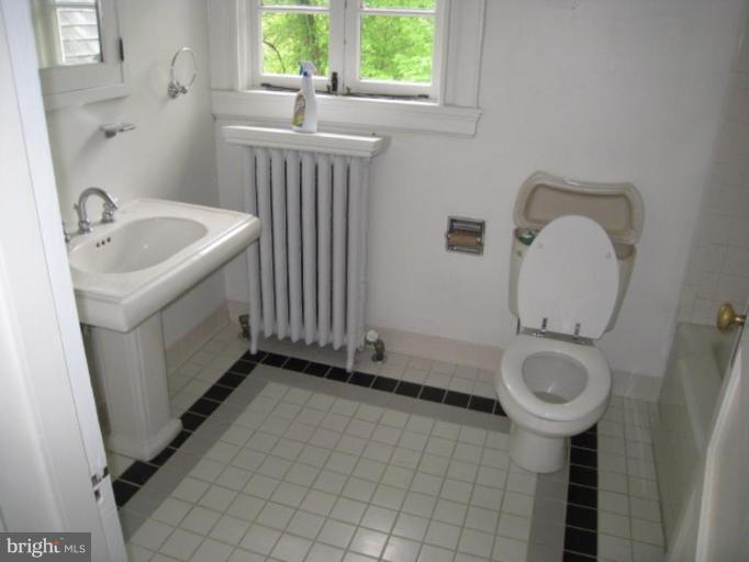 5305 Falls Rd Terrace Baltimore, MD 21210 - Photo 7 of 20 a bathroom with a sink a toilet and a window