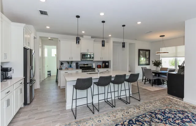 a large kitchen with a table and chairs