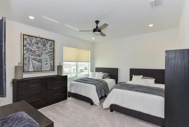 a bedroom with two beds and a window