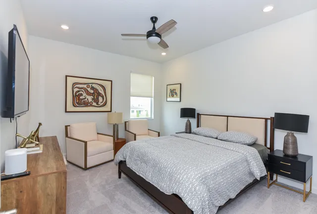 a bedroom with bed and a chandelier