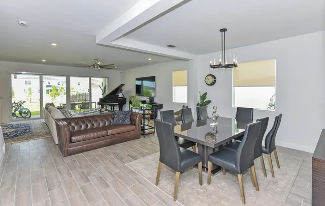 a living room with furniture and a chandelier