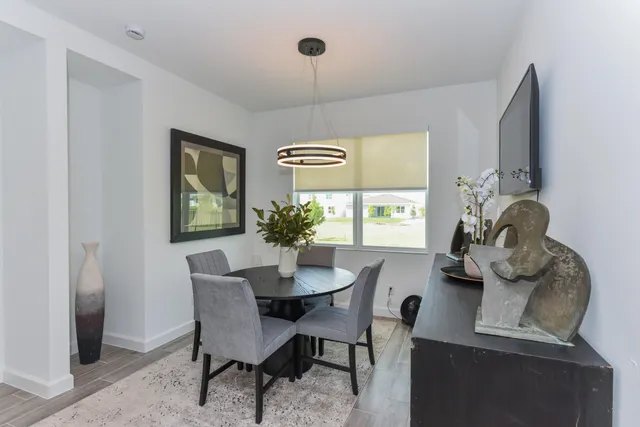 a dining room with furniture and window