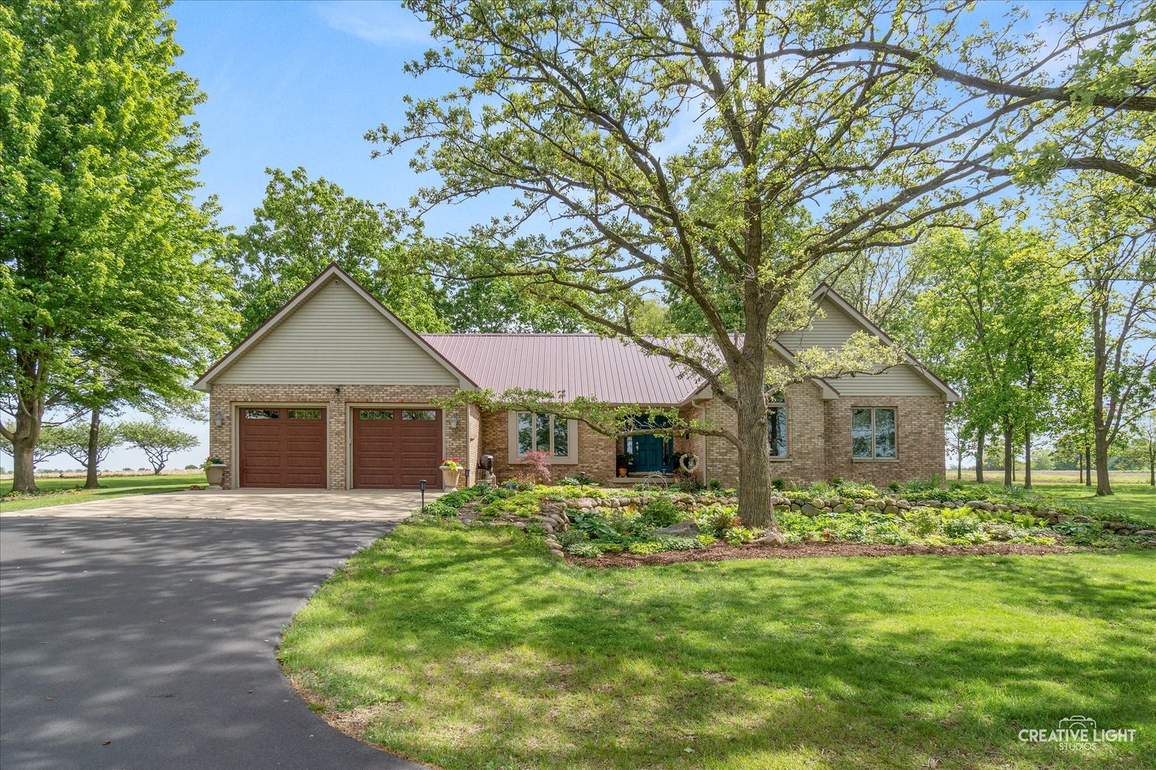 a front view of house with yard and green space