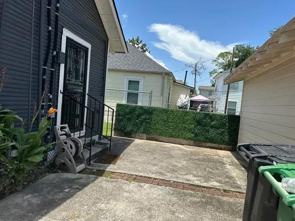 a view of backyard with a table and chairs and potted plants