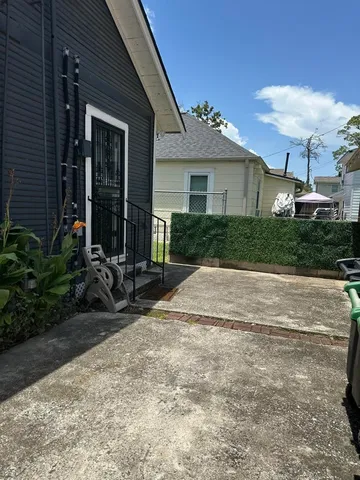 a front view of a house with a yard and potted plants