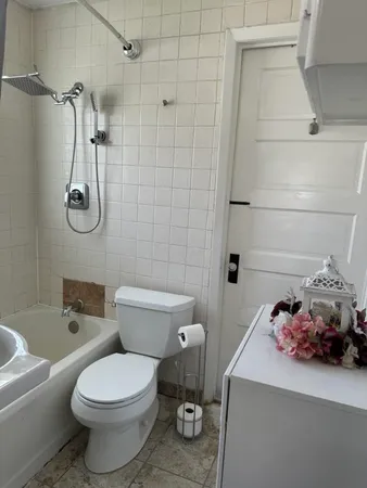 a bathroom with a sink toilet and shower