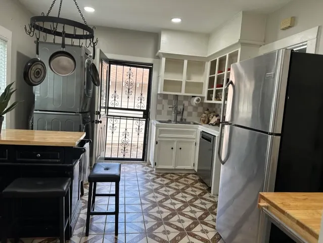 a kitchen with a refrigerator a stove and a sink