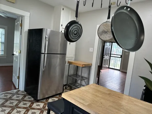 a kitchen with stainless steel appliances granite countertop a refrigerator a stove and a sink