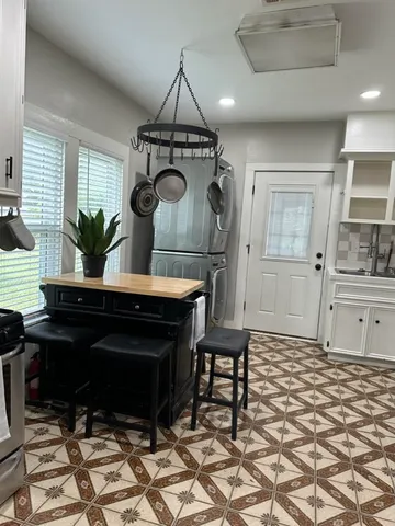 a living room with a table and chairs